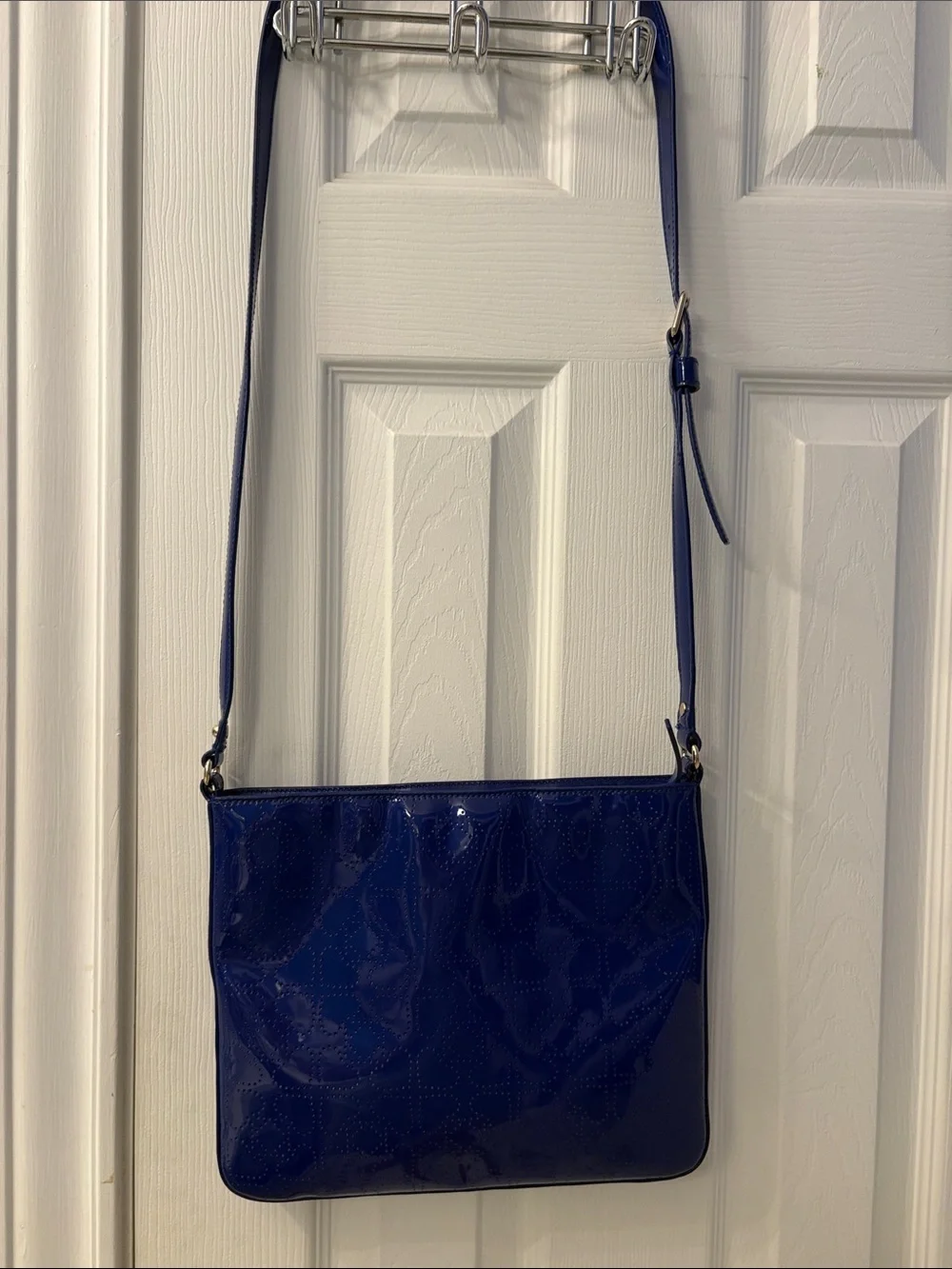 Kate Spade heart perforated patent leather crossbody in cobalt blue.